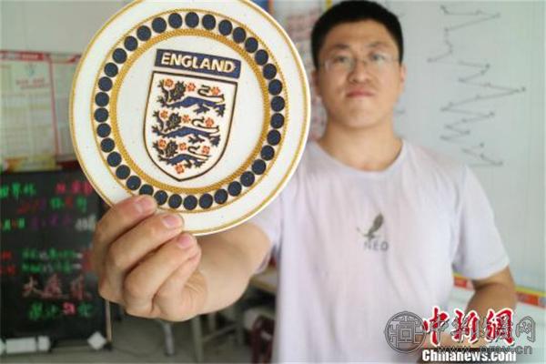 足球爱好者吕一民展示英格兰国家队队徽.jpg